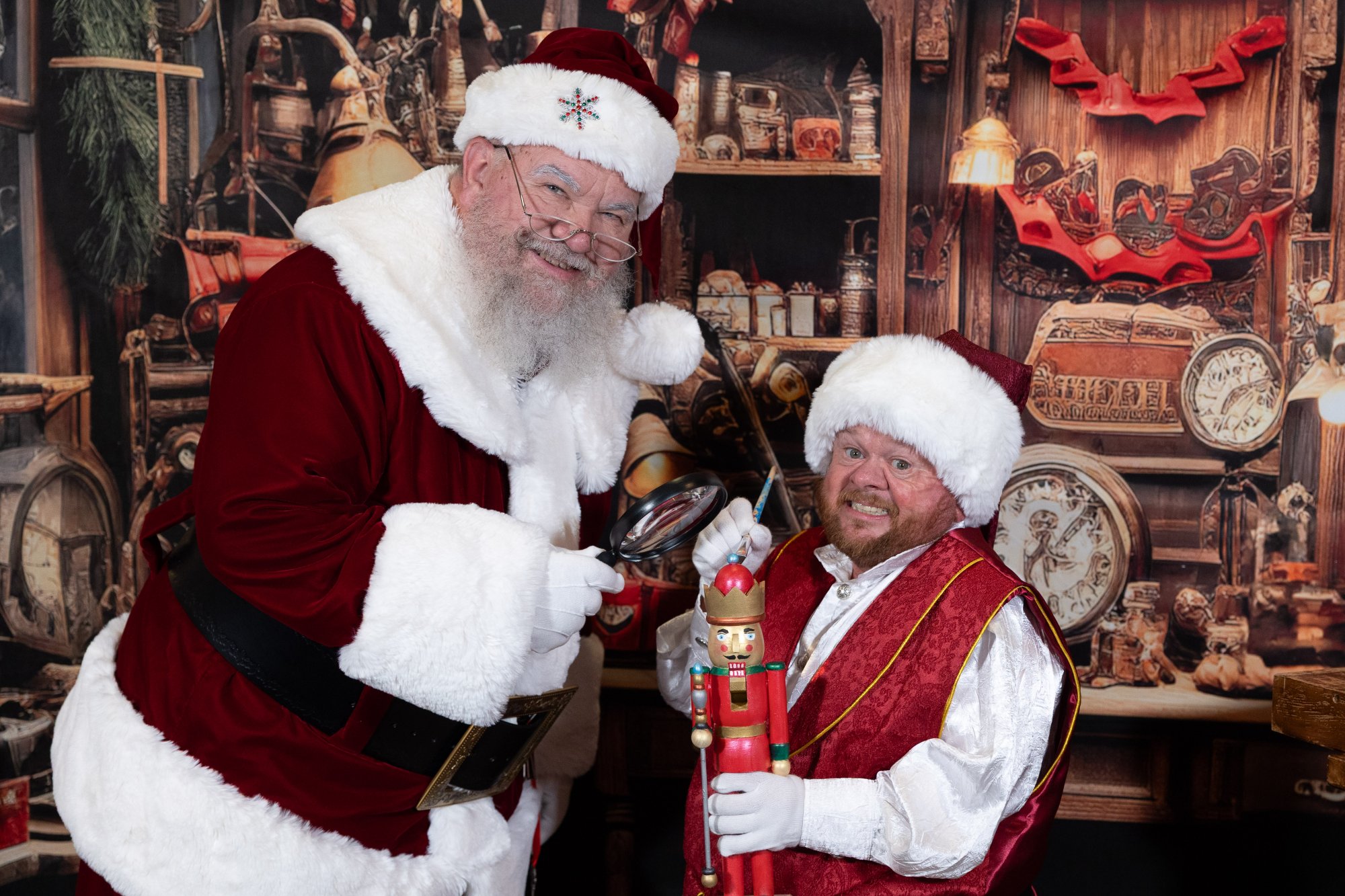 Santa Strickland and his elf side by side in the toy workshop