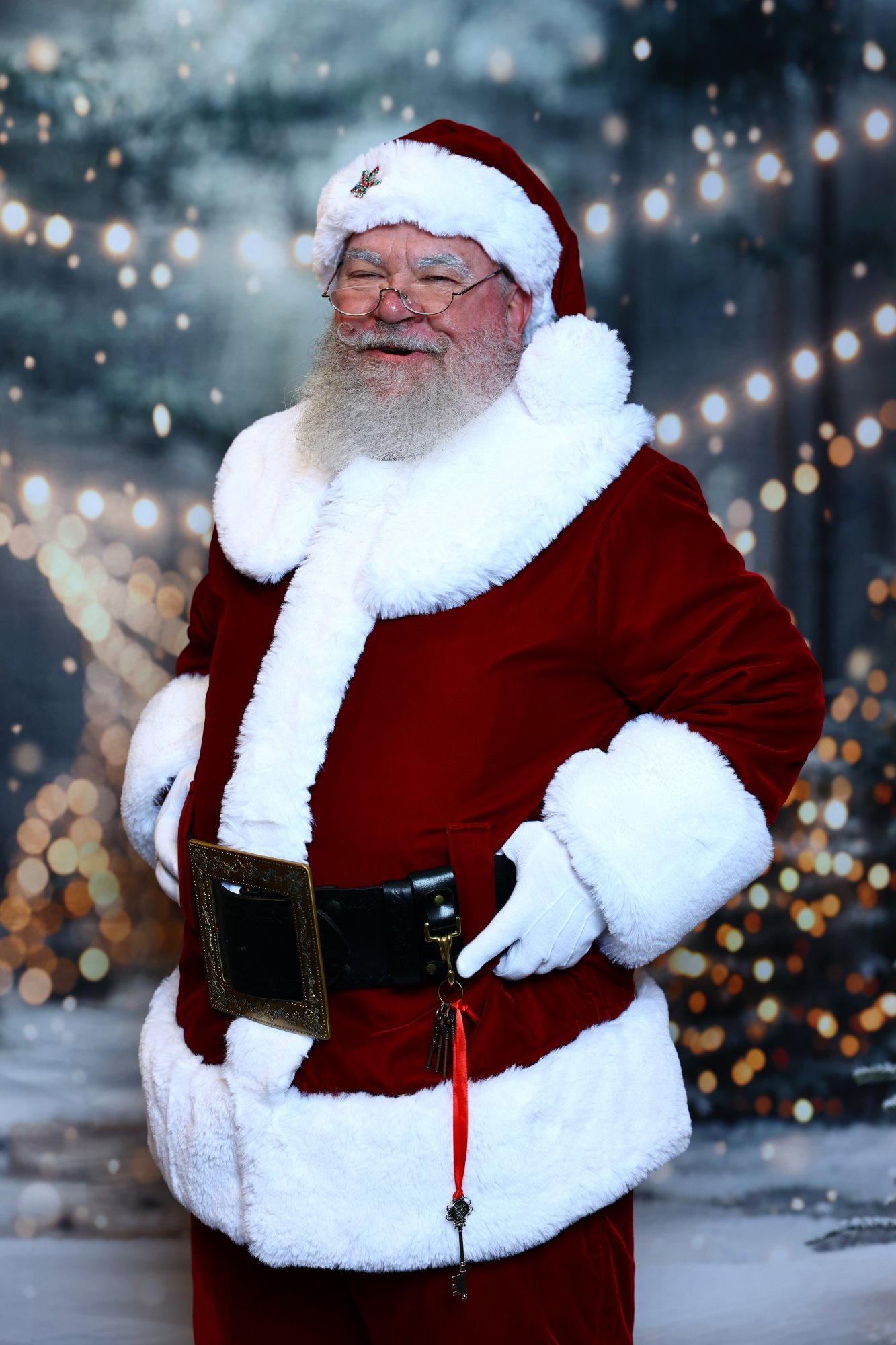 Santa Strickland winter portrait, hands on his hips with a warm smile